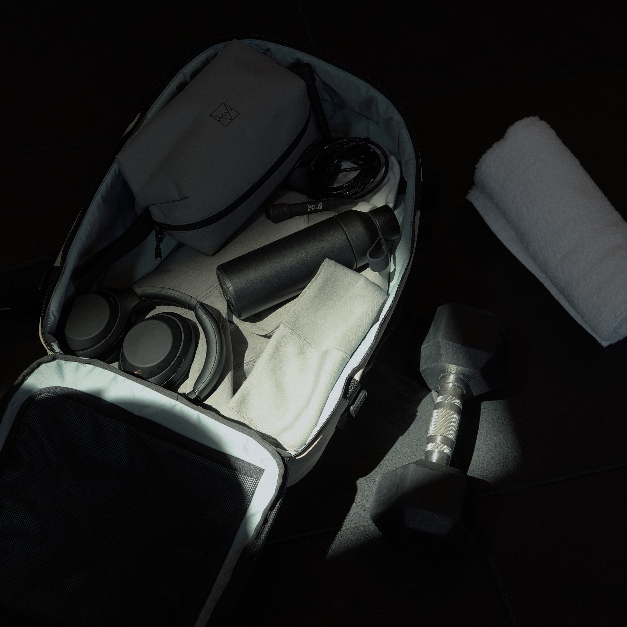 A packed interior of the Hybrid Backpack 30L in Sand, packed with gym accesories