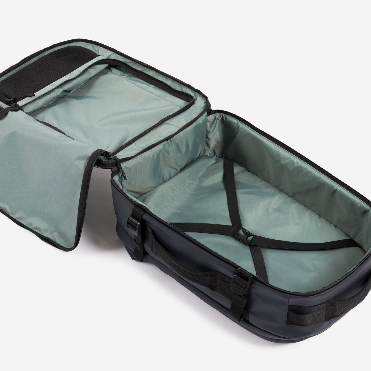 A studio shot of the interior compartment and compression strap on the Hybrid Backpack 30L in Midnight Blue