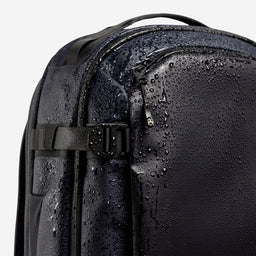 A studio shot of the compression straps and waterproof material on the Hybrid Backpack 30L in Midnight Blue