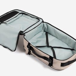 A studio shot of the interior compartment within the Hybrid Backpack 30L in Sand