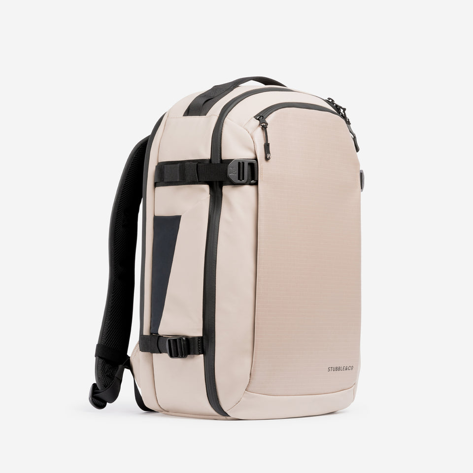 A studio shot of the front and side of the Hybrid Backpack 30L in Sand