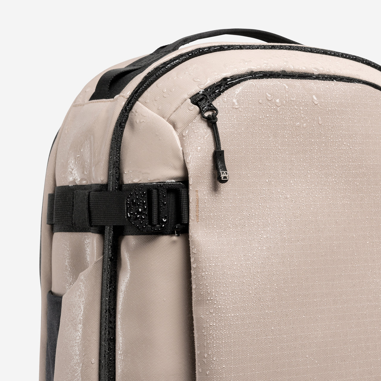 A studio shot of the waterproof material on the Hybrid Backpack 30L in Sand