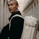 A close up of the Hybrid Backpack 30L in Tonal Sand on a man's back