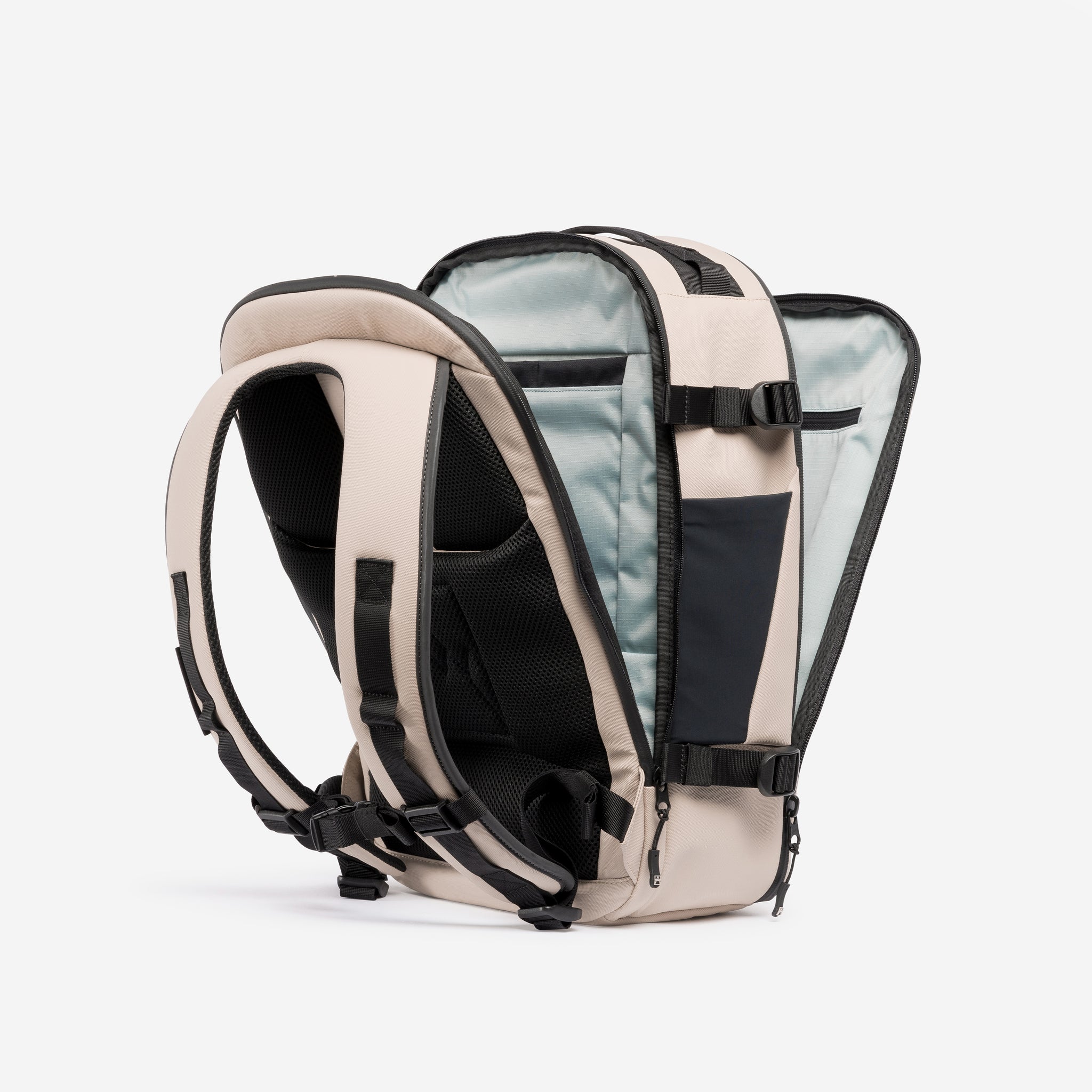 A studio shot of the clam shell opening on the Hybrid Backpack 20L in Sand
