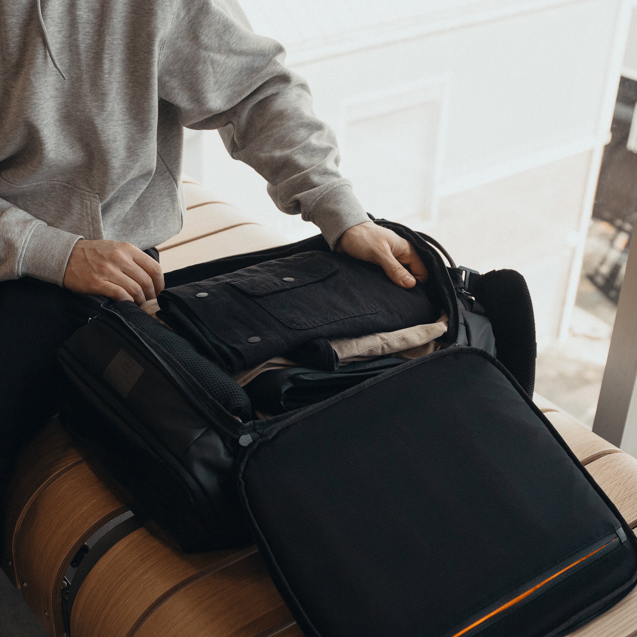 an interior shot of a packed All Black Kit Bag 30L on a bench