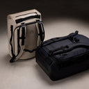 A studio creative shot of the Kit Bag 30L in  midnight blue and Sand