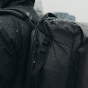 A close up shot of an All Black Kit Bag 30L in the rain