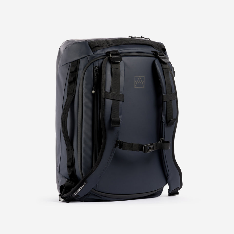 A studio shot of the front and chest straps on the Kit Bag 30L in Midnight Blue