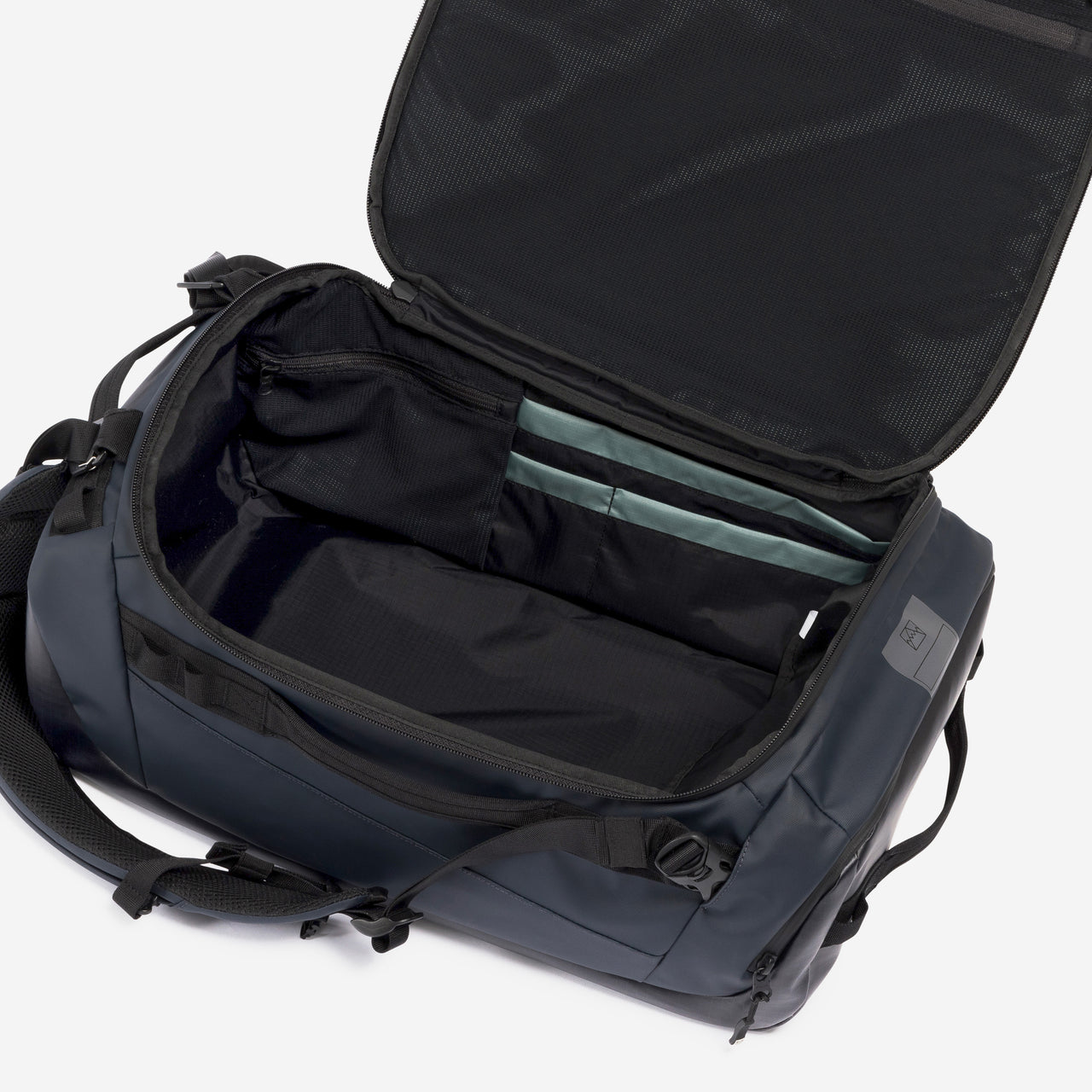 A studio shot of the interior compartment within the Kit Bag 30L in Midnight Blue
