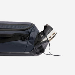 A studio shot of the shoe compartment on the Kit Bag 30L in Midnight Blue