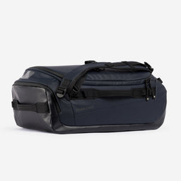 A studio shot of the side and end of the Kit Bag 30L in Midnight Blue