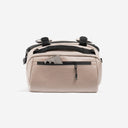 A studio shot of the easy access pocket with a phone in on the Kit Bag 30L in Sand