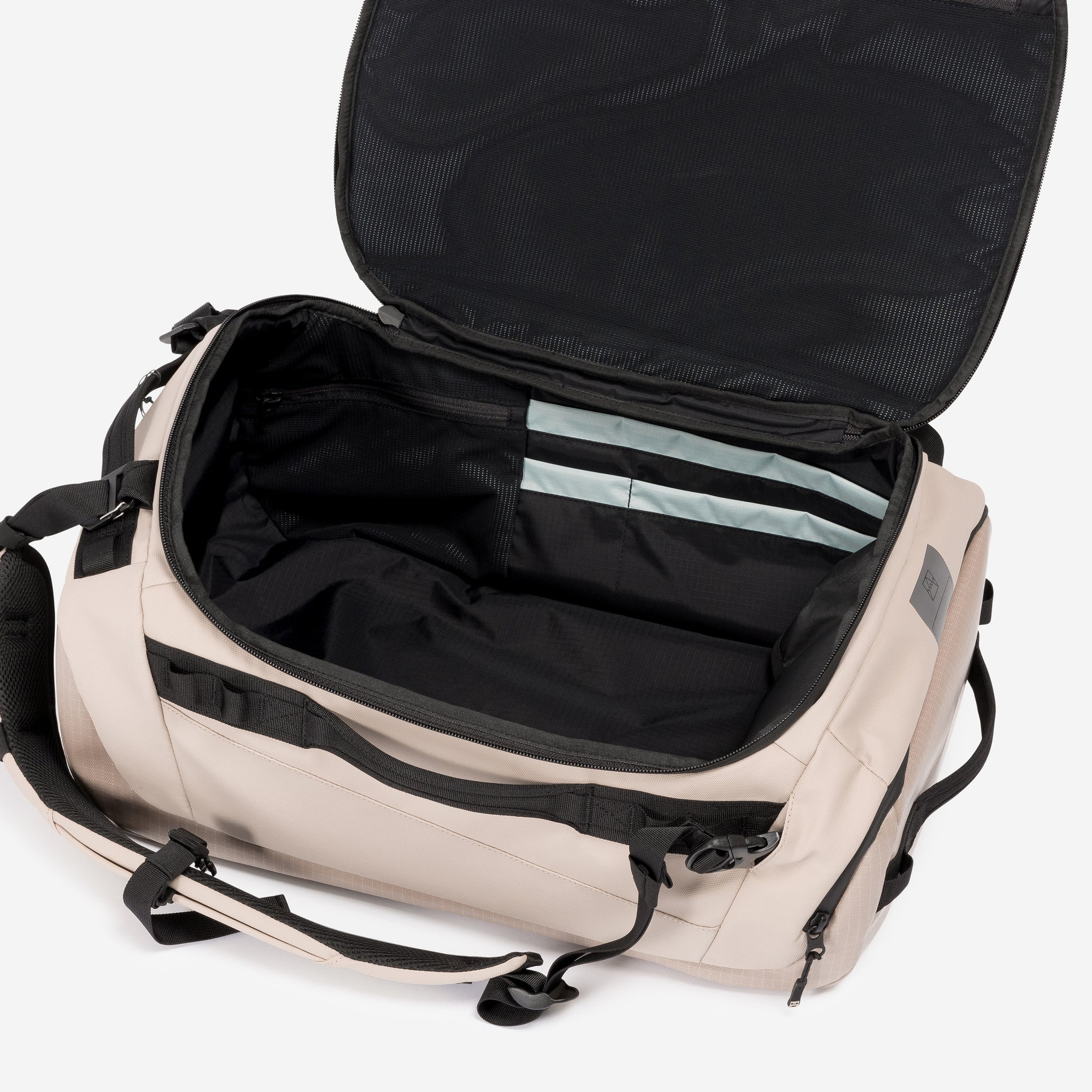 A studio shot of the interior compartment within the Kit Bag 30L in Sand