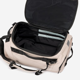 A studio shot of the interior compartment within the Kit Bag 30L in Sand