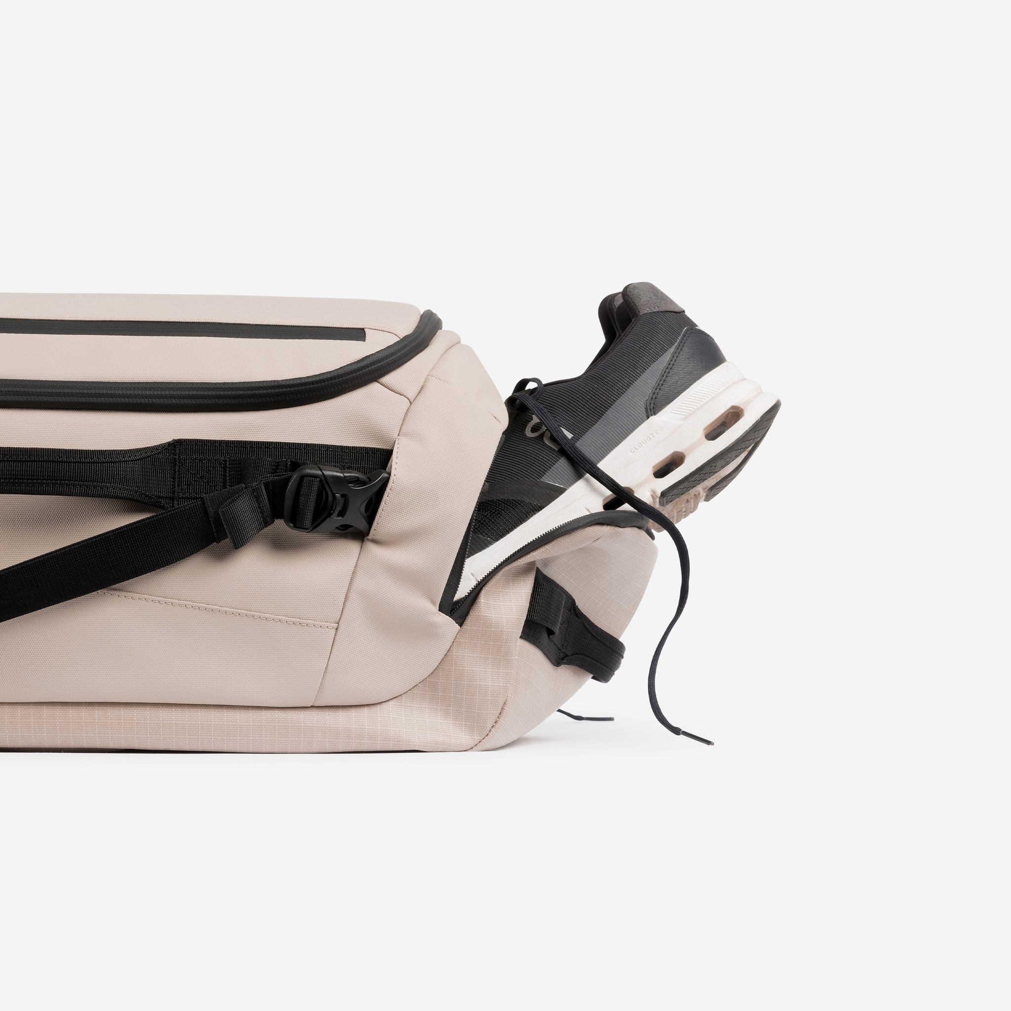 A studio shot of the shoe compartment on the Kit Bag 30L in Sand