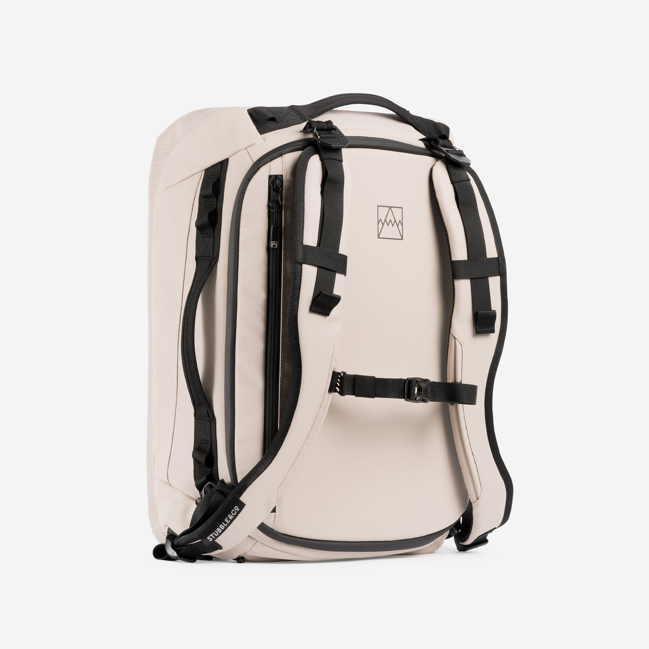 A studio shot of a kit bag 30l in Sand standing on its end showing the chest straps