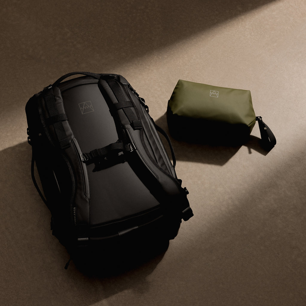 a studio shot of the kit bag 30l and green wash bag on the floor as a creative flat lay
