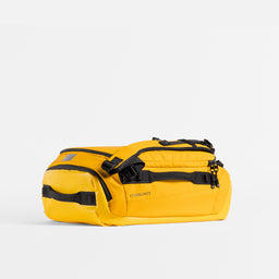 Kit Bag 30L in Yellow resting horizontally on a plain white background. 