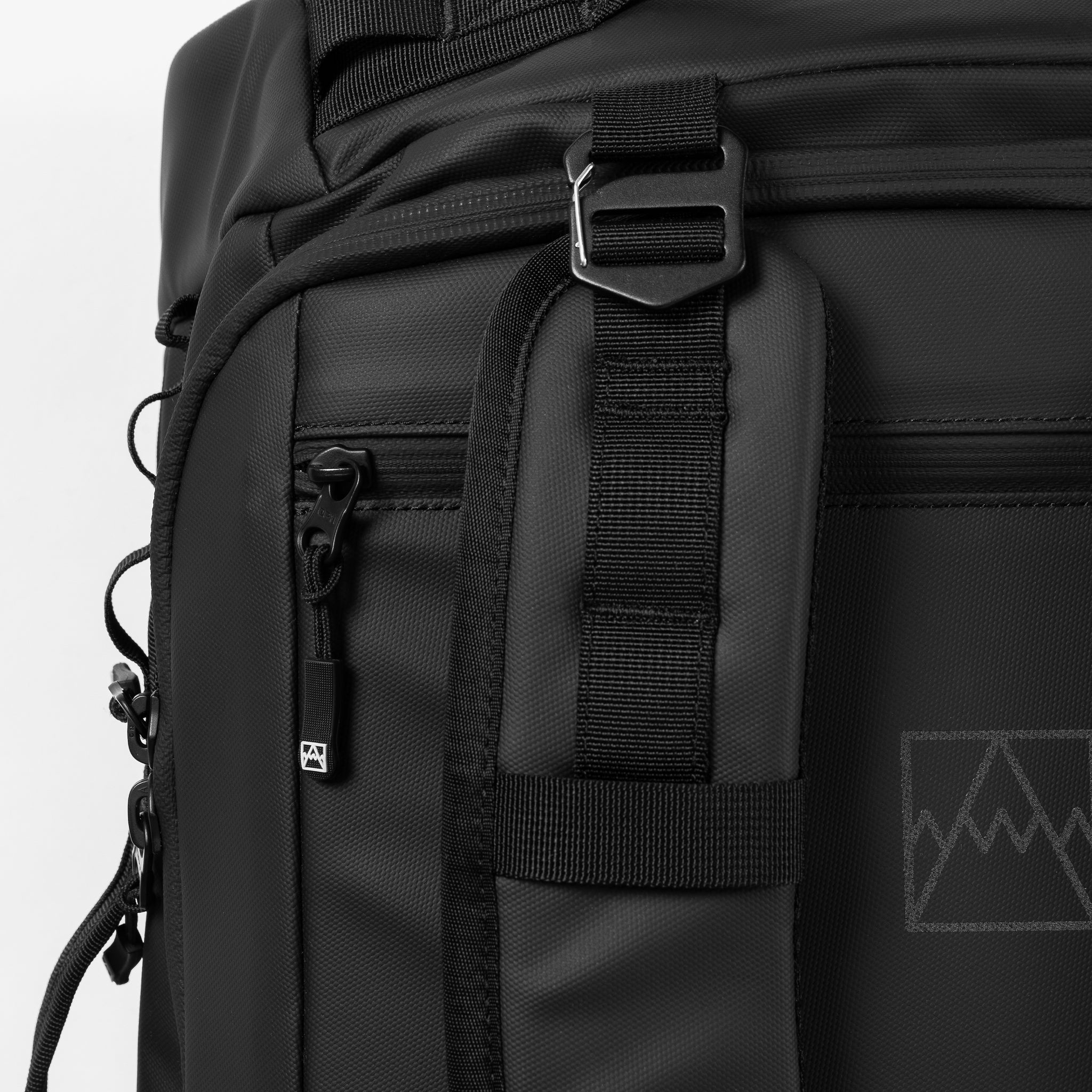 A close up of the adjustable and removable straps on the Kit Bag 40L in All Black