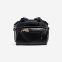 A studio shot of the easy access pocket with a phone in it on the Kit Bag 40L in Midnight Blue