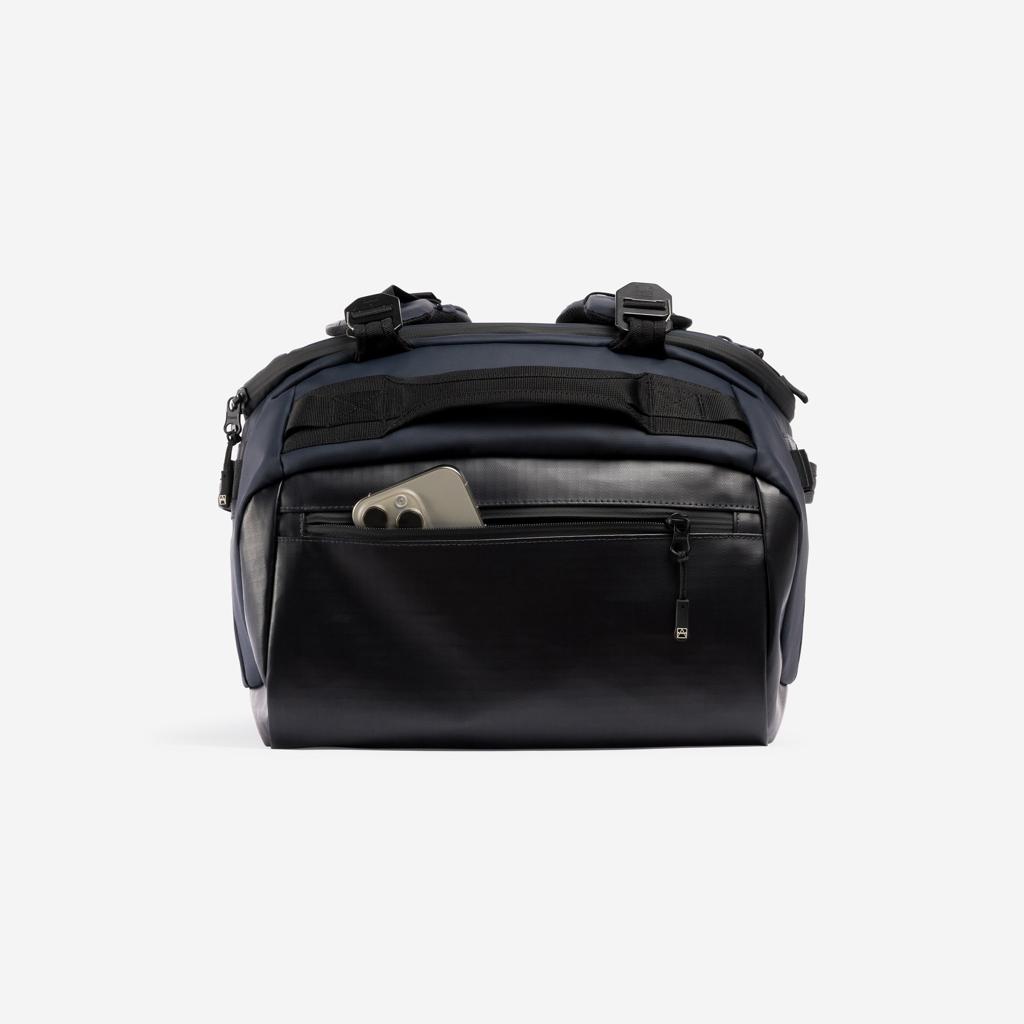 A studio shot of the easy access pocket with a phone in it on the Kit Bag 40L in Midnight Blue