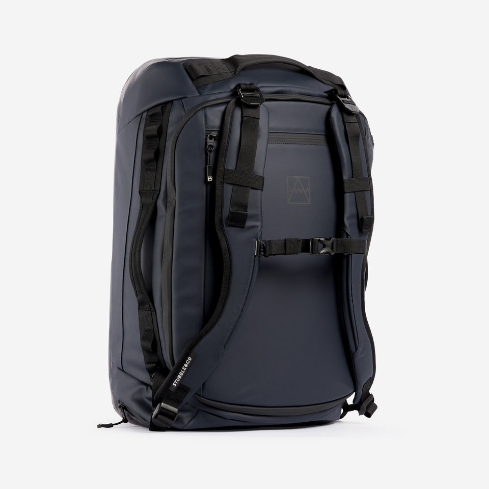 A studio shot of the front and chest straps on the Kit Bag 40L in Midnight Blue