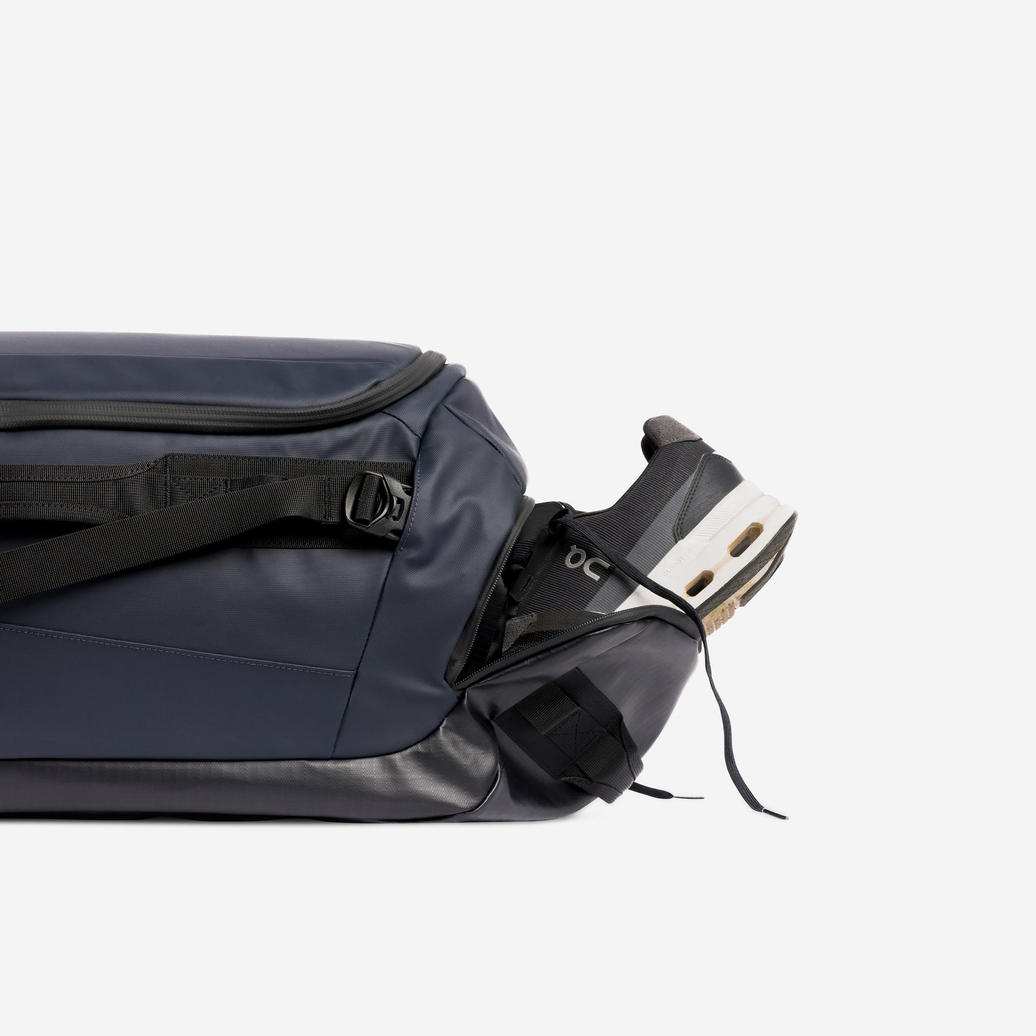 A studio shot of the shoe compartment on the Kit Bag 40L in Midnight Blue