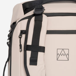 A close up of the adjustable and removable straps on the Kit Bag 40L in Sand