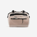 A studio shot of the easy access pcoket with a phone in it on the Kit Bag 40L in Sand