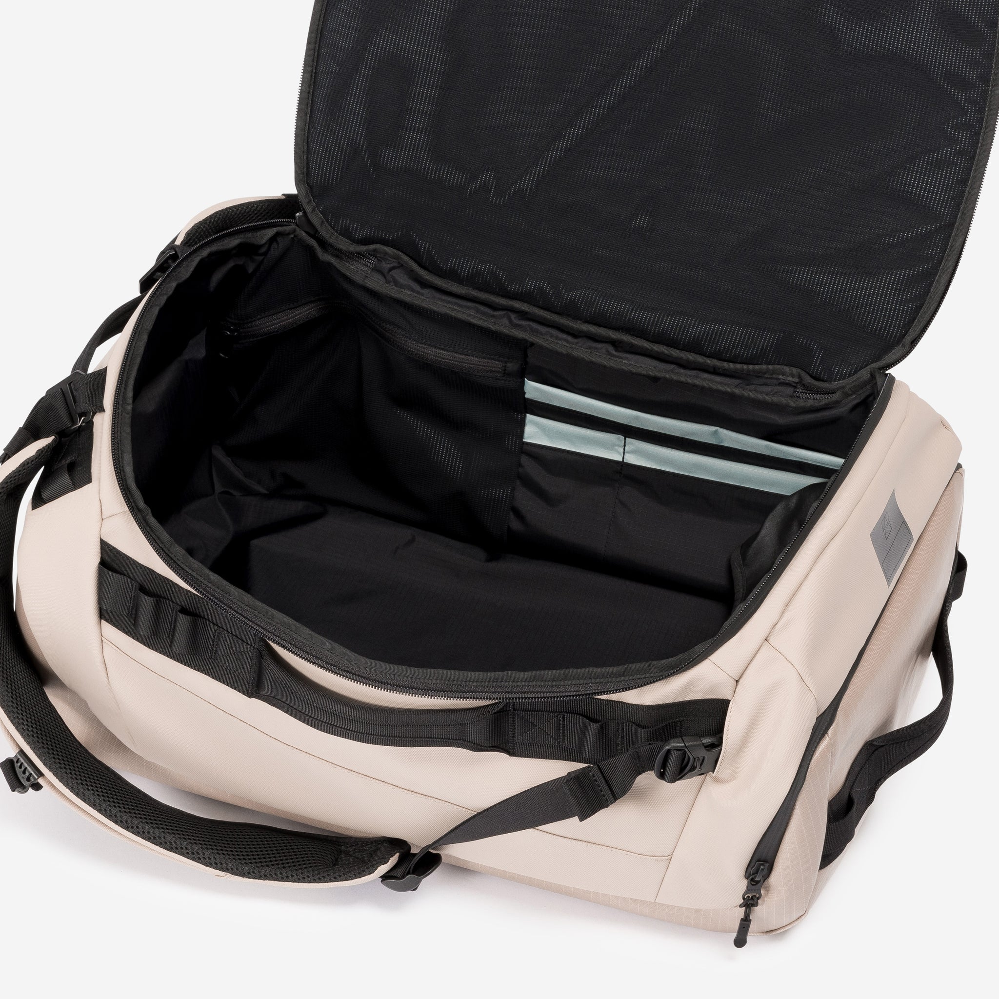 A studio shot of the interior compartment on the Kit Bag 40L in Sand