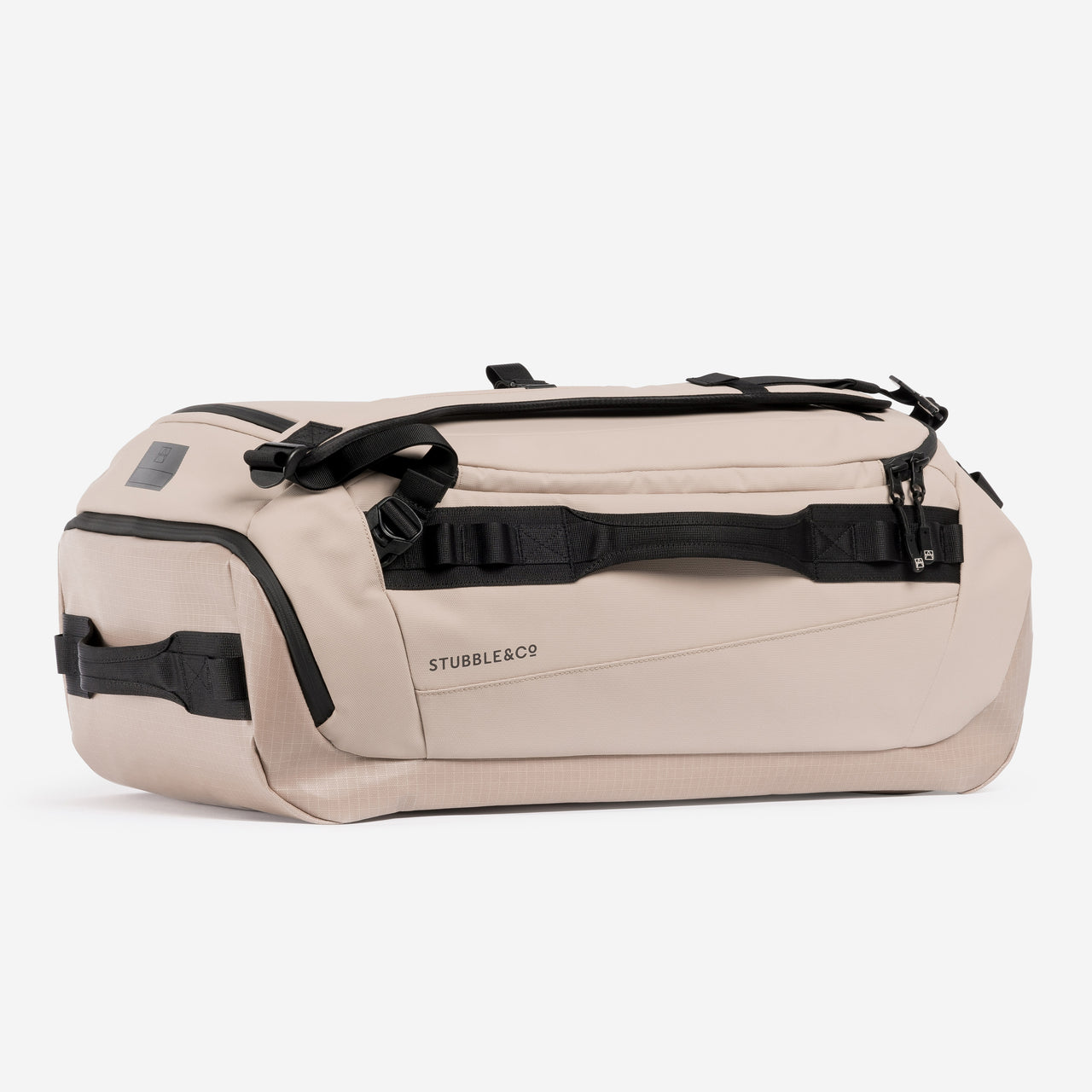 A studio shot showing the side and end of a Kit Bag 40L in Sand