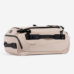 A studio shot showing the side and end of a Kit Bag 40L in Sand