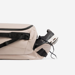 A studio shot of the shoe compartment on the Kit Bag 40L in Sand