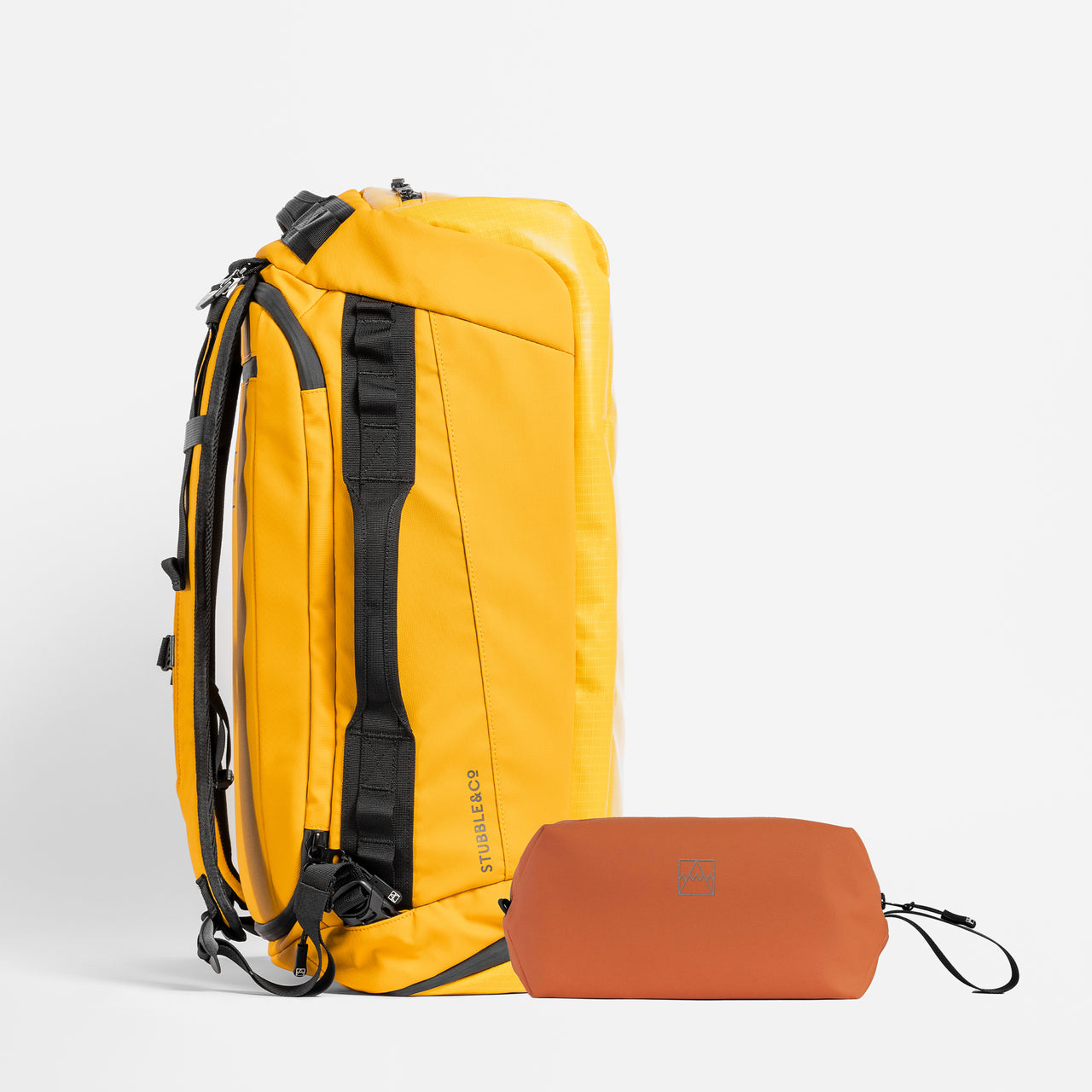 A studio shot of the Kit Bag 40L Yellow / Rust Wash Bag bundle