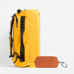A studio shot of the Kit Bag 65L in Yellow / Rust Wash Bag bundle