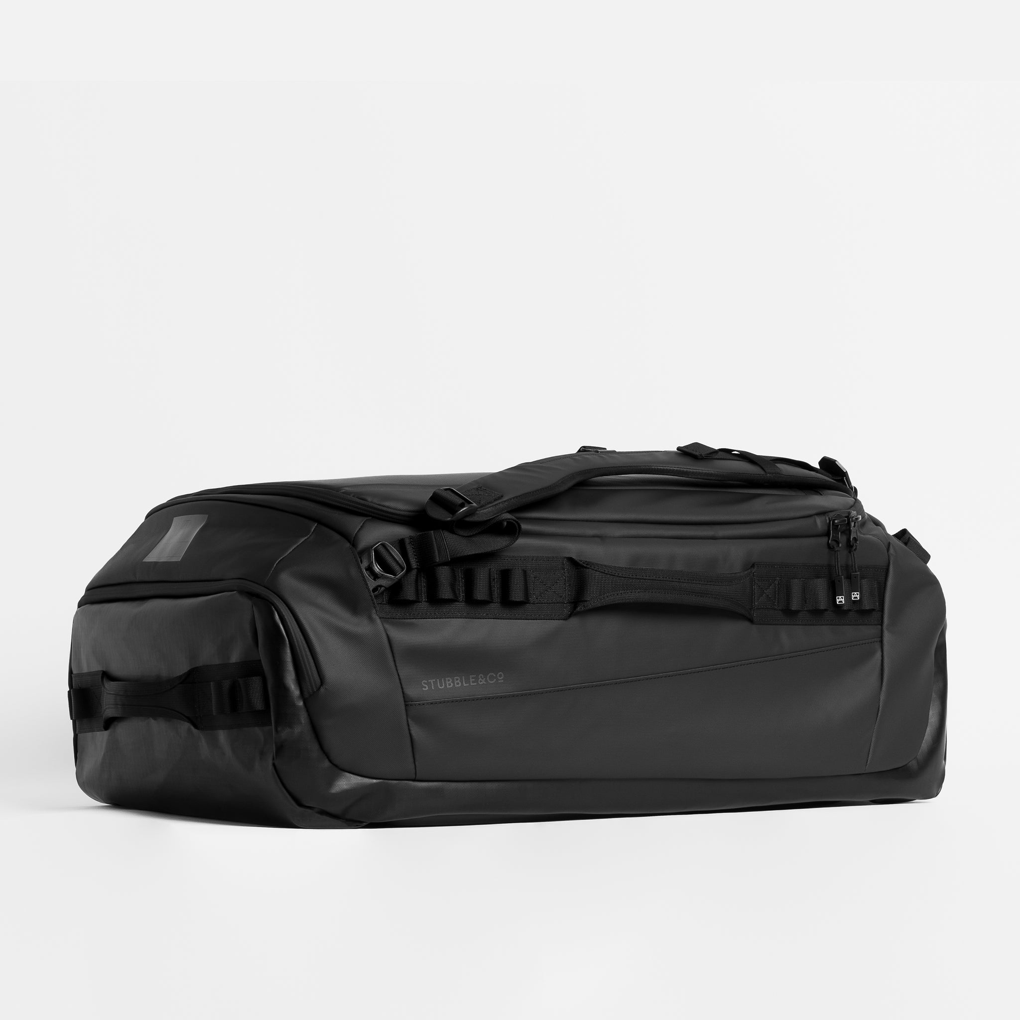 Kit Bag 65L in All Black resting horizontally against a plain white background. 
