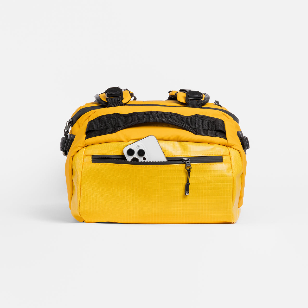 A studio shot of the end pocket with a phone in on the Kit Bag 65L in Yellow