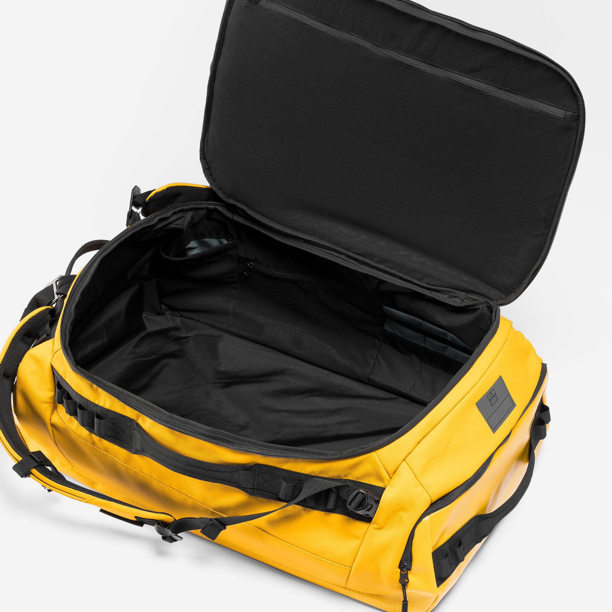 A studio shot of the interior compartment in a Kit Bag 65L in Yellow