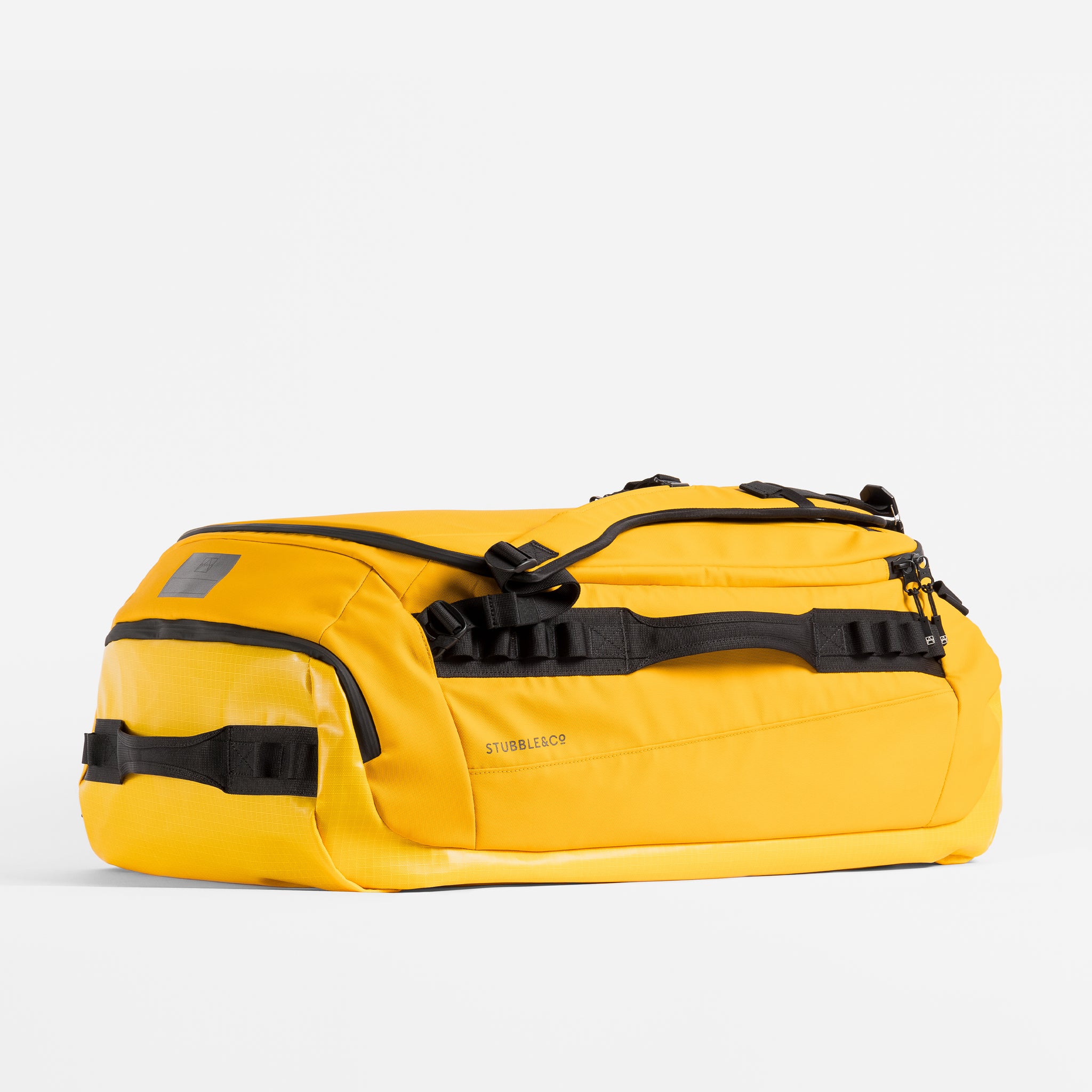 Kit Bag 65L in Yellow resting horizontally on a plain white background. 