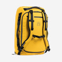 A studio shot of the Yellow Kit Bag 65L standing up showing the back straps