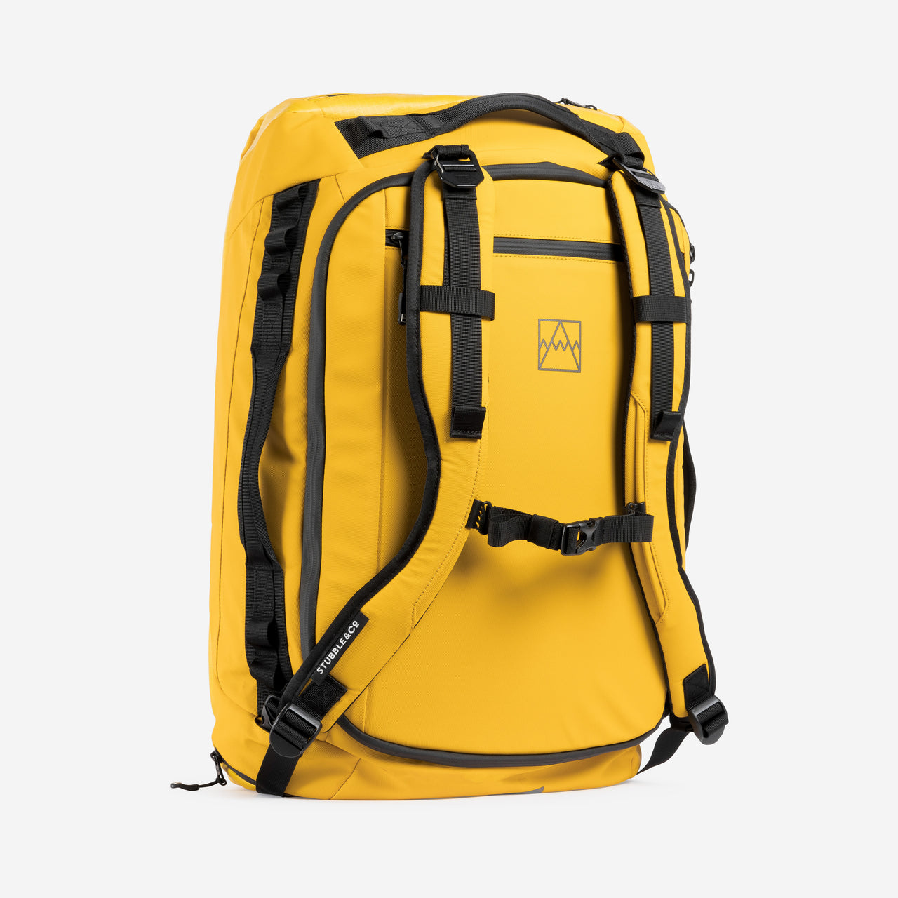 A studio shot of the Yellow Kit Bag 65L standing up showing the back straps