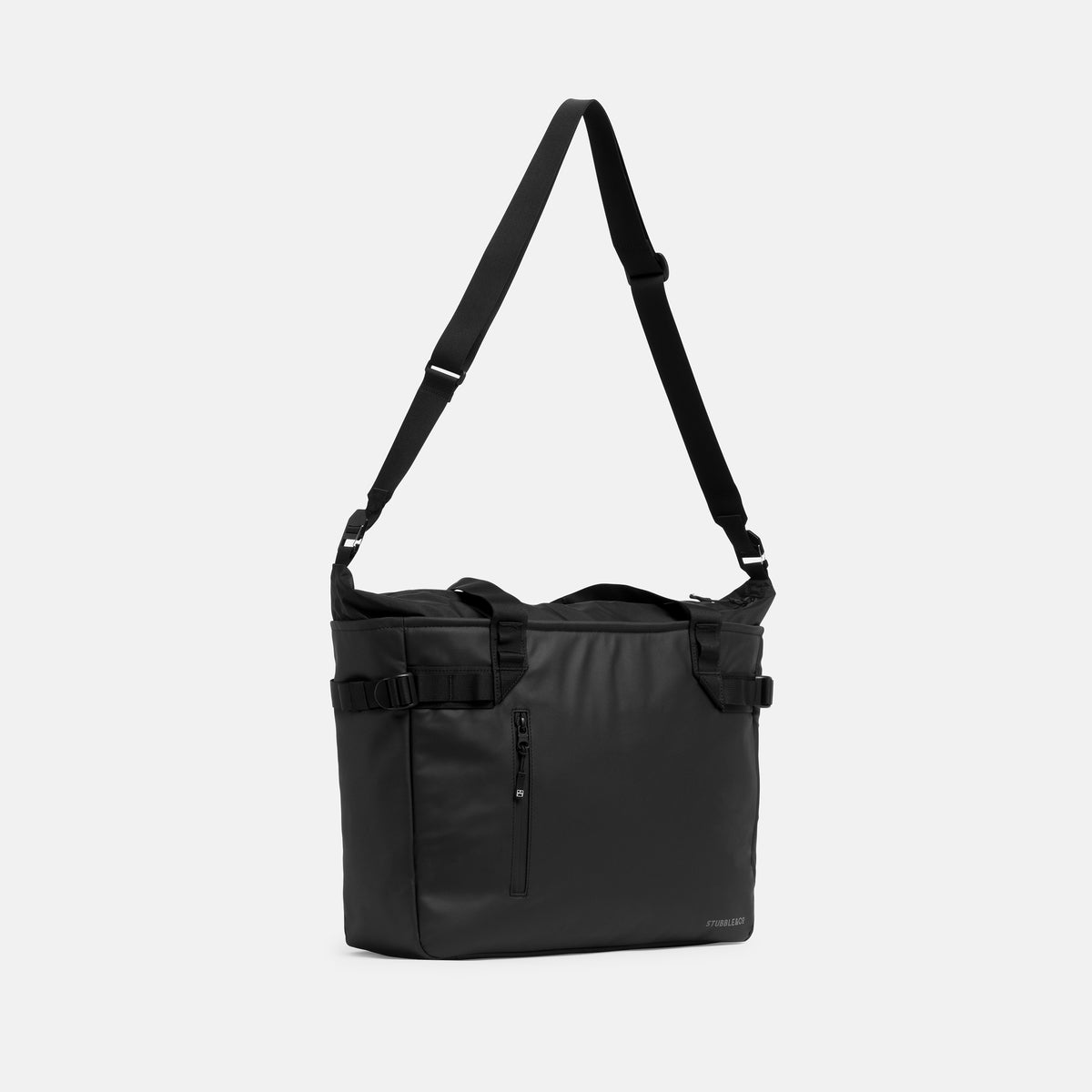 A studio shot of the All Black Laptop Tote 20L with the long strap hanging up