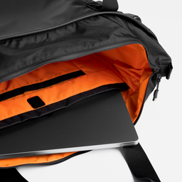 A studio shot of the inside of the laptop toe 20l in All Black showing the laptop compartment