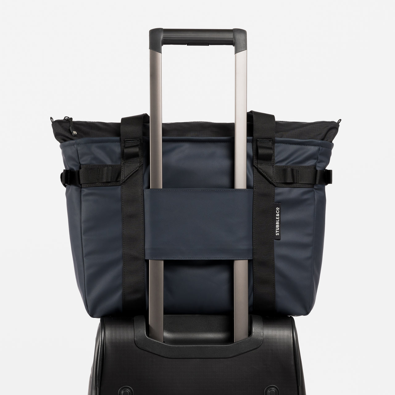 A studio shot showing the luggage sleeve on the Midnight Blue Laptop Tote Bag 20L