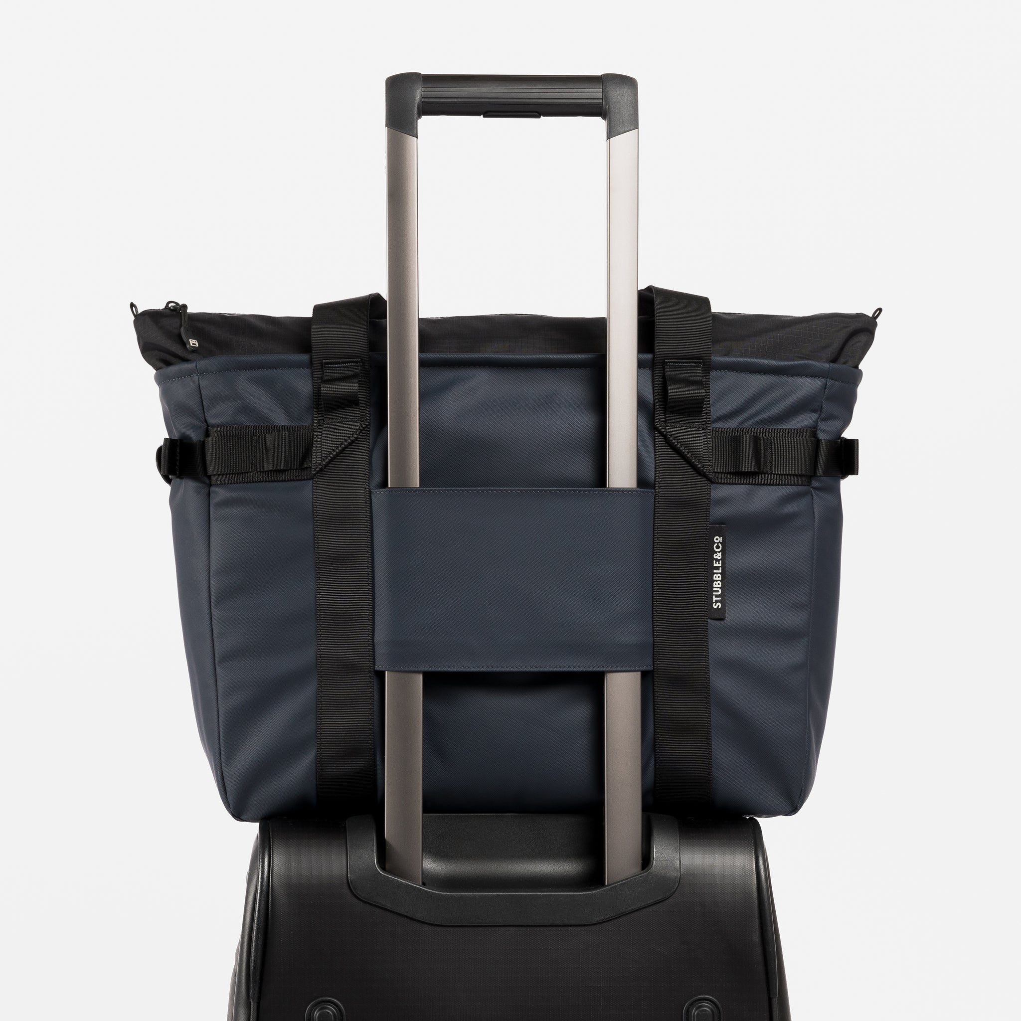 A studio shot showing the luggage sleeve on the Midnight Blue Laptop Tote Bag 20L