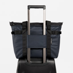 A studio shot showing the luggage sleeve on the Midnight Blue Laptop Tote Bag 20L