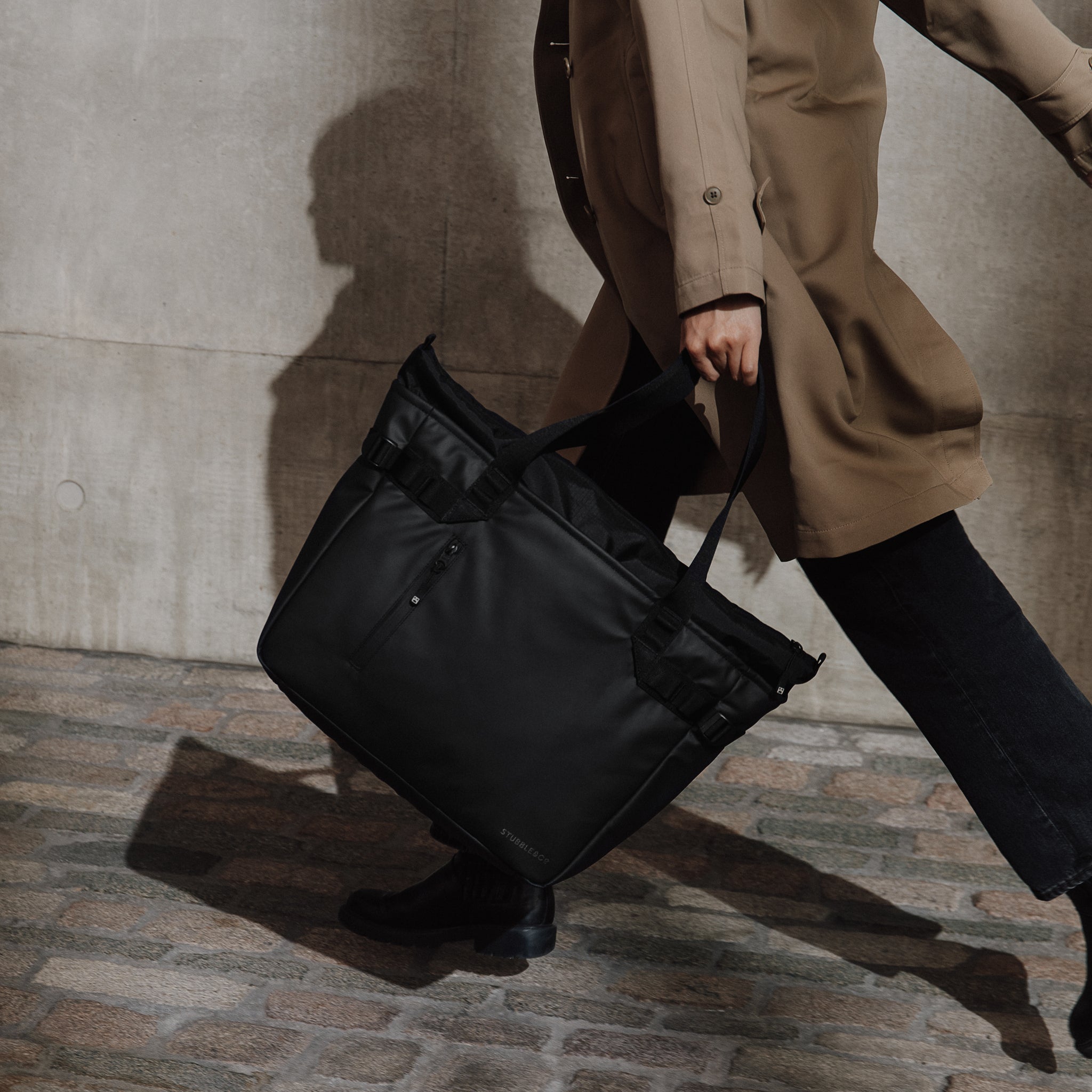 A woman running with a tote bag by her side