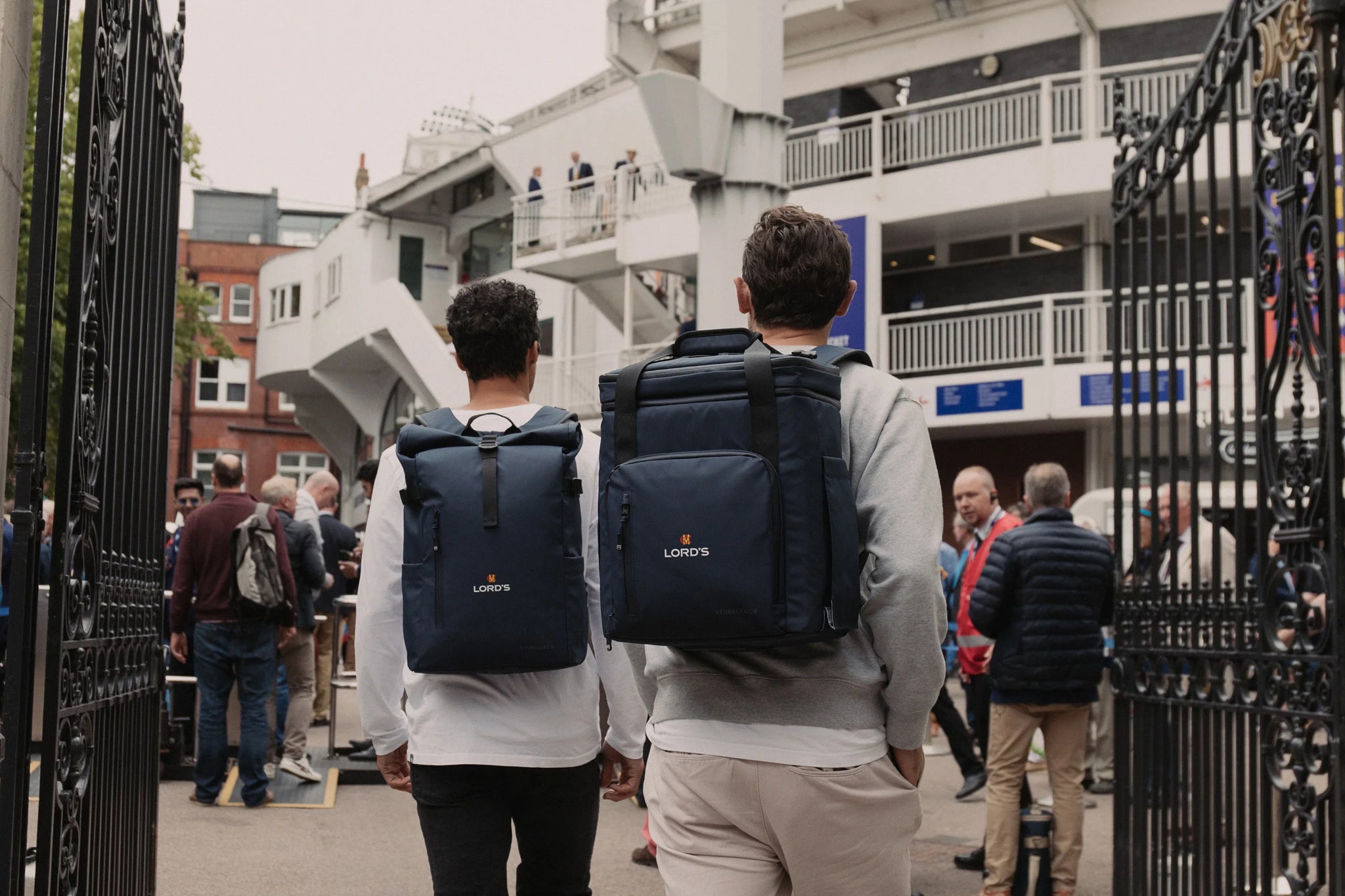 Men wearing navy cooler backpack at the cricket