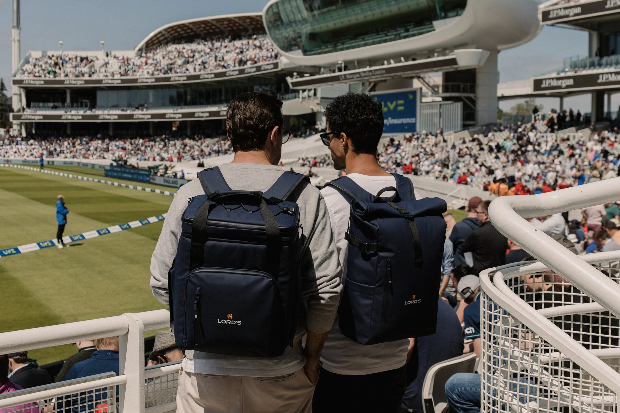 Men wearing navy cooler backpack at the cricket