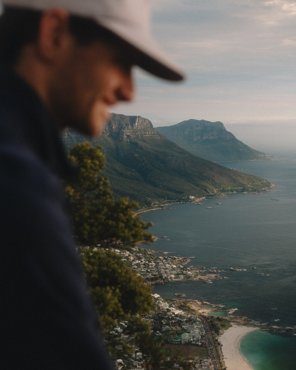 Man overlooking Camps Bay from Lion's Head Mountain